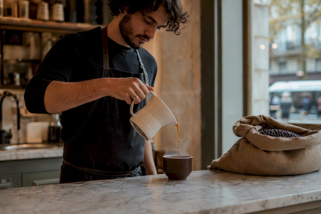 Barista pouring fresh specialty coffee
