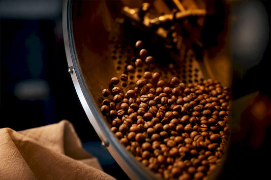 Round peaberries tumbling inside roasting drum