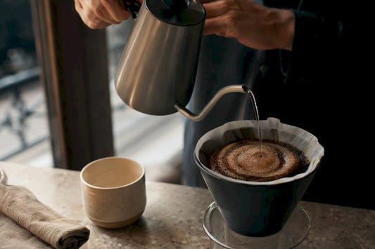 Controlled spiral pour over coffee brewing
